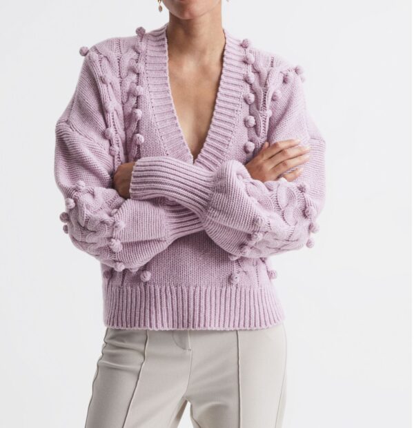 Deep V-neck pullover sweater with pompons